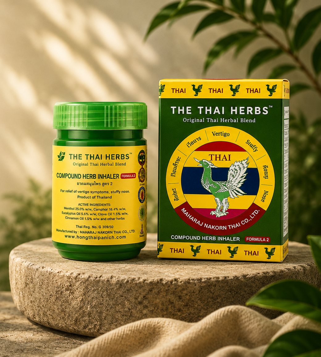 The Thai Herbs herbal inhaler and box on a natural stone platform